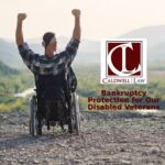 A veteran in a wheelchair raising his arms in triumph on a mountain overlook, featuring the Caldwell Law logo and text "Bankruptcy Protection for Our Disabled Veterans."